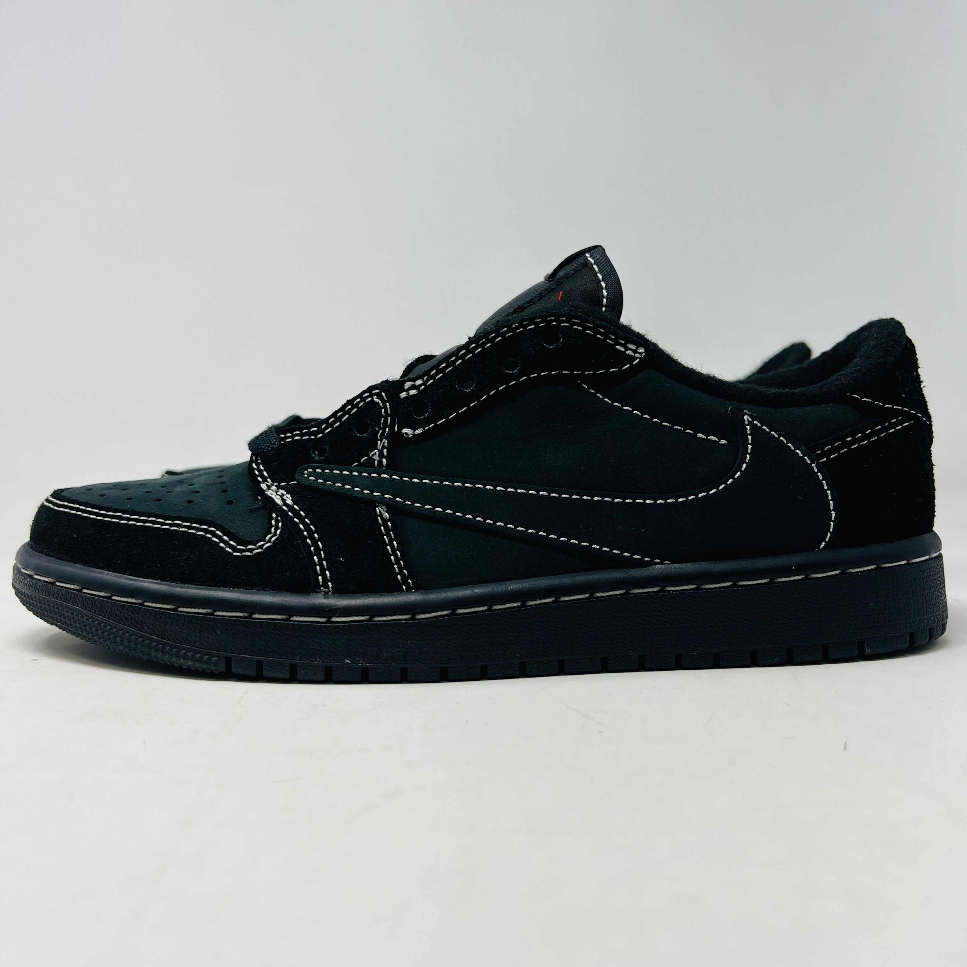 Jordan 1 Retro Low OG SP Travis Scott Black Phantom sneakers with reverse Swoosh and hidden stash pocket.