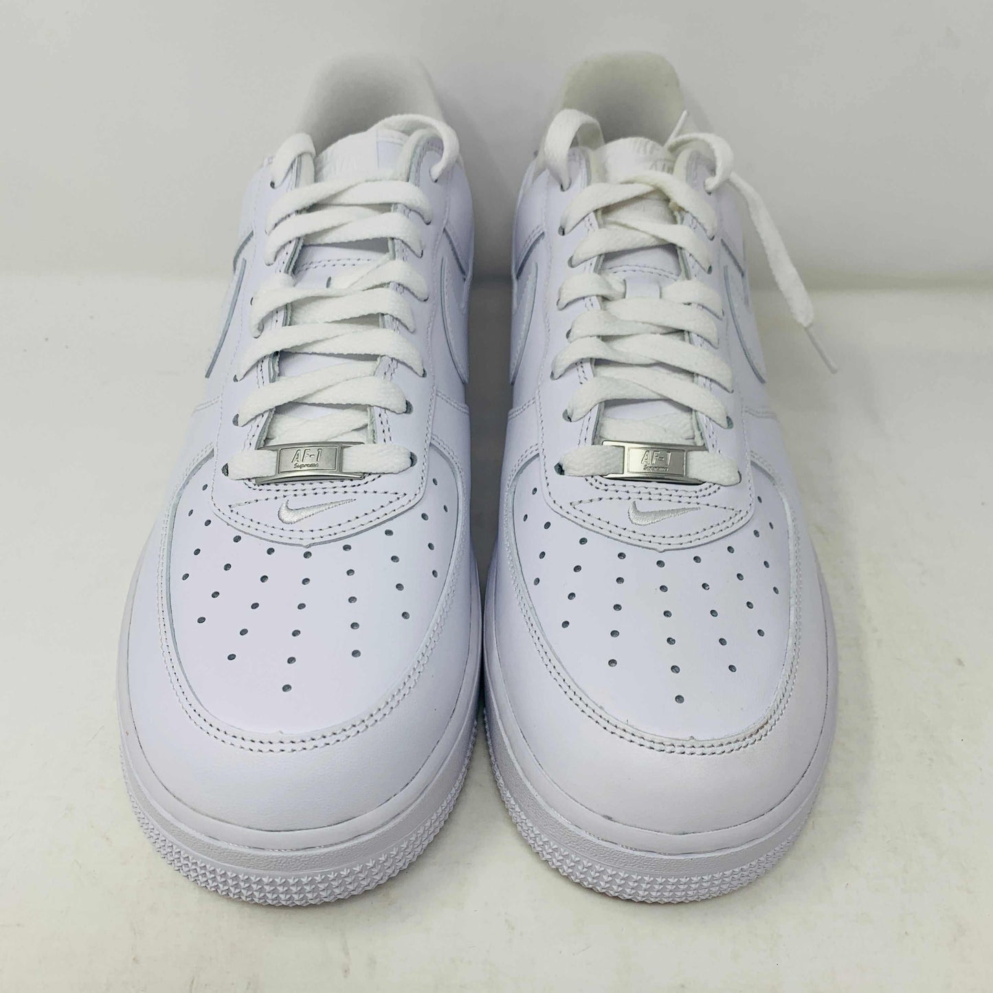 Supreme Air Force 1 White sneakers with classic design and Supreme branding.