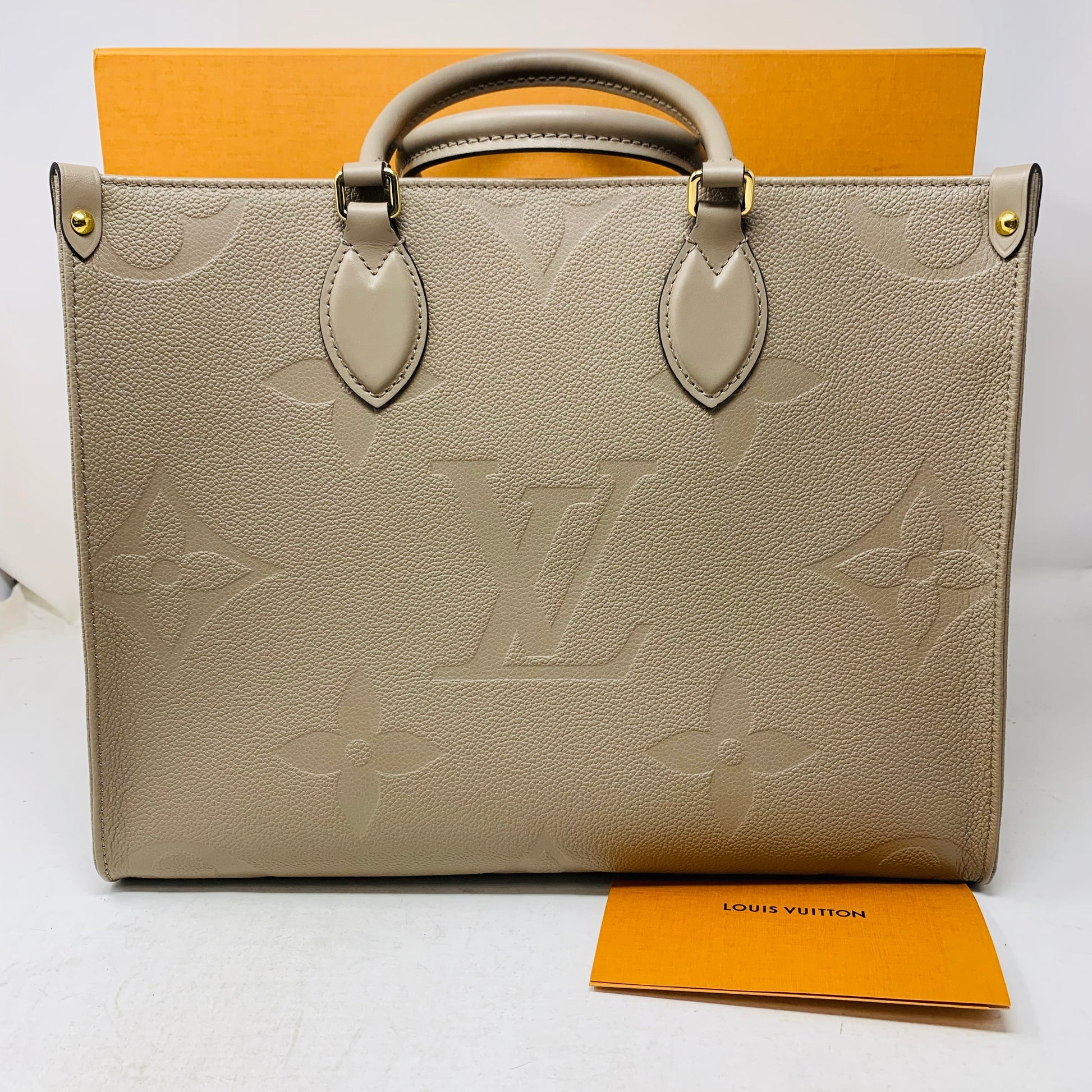 Louis Vuitton Onthego Tote PM in Tourterelle Beige Cream Leather with Monogram Empreinte pattern, brand new with box and dust bag.