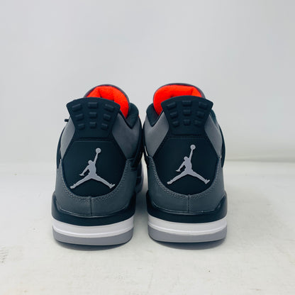 A pair of Jordan 4 Infrared sneakers by Jordan, featuring a gray mesh panel, black laces, and red accents with a distinctive logo on the tongue. They are positioned side by side on a white surface against a plain background.