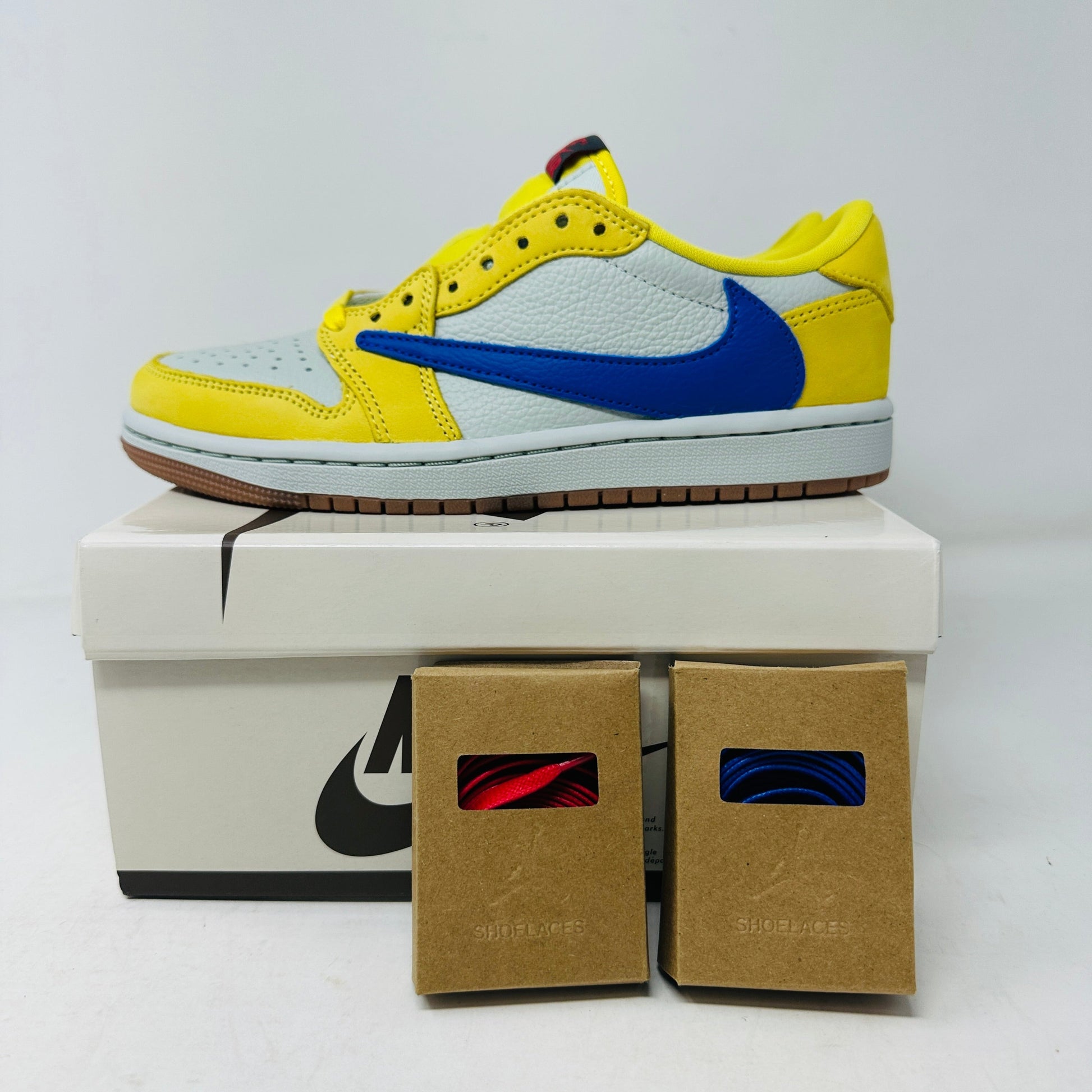 Jordan 1 Retro Low OG SP Travis Scott Canary Women's sneakers with extra laces on box.