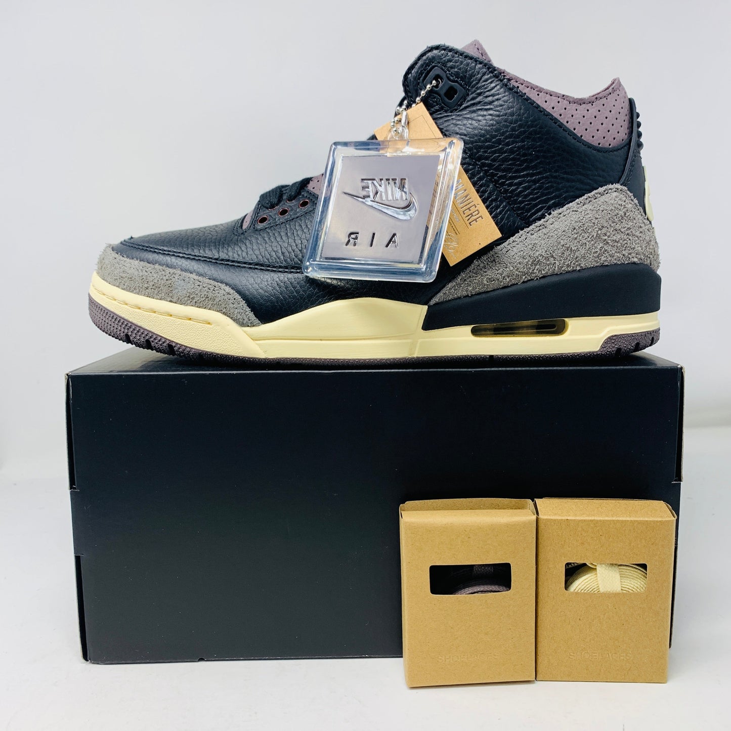 Jordan 3 Retro OG SP A Ma Maniére Women's sneaker with extra laces, hang tag, and purple rag.