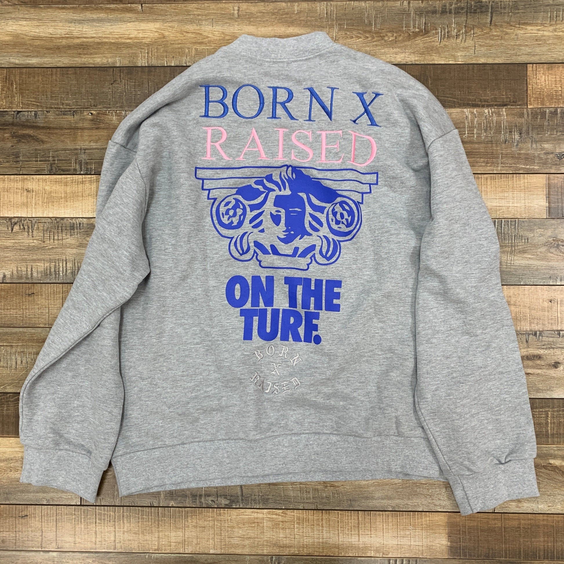 Born x Raised Grey Crewneck sweatshirt with graphic design.