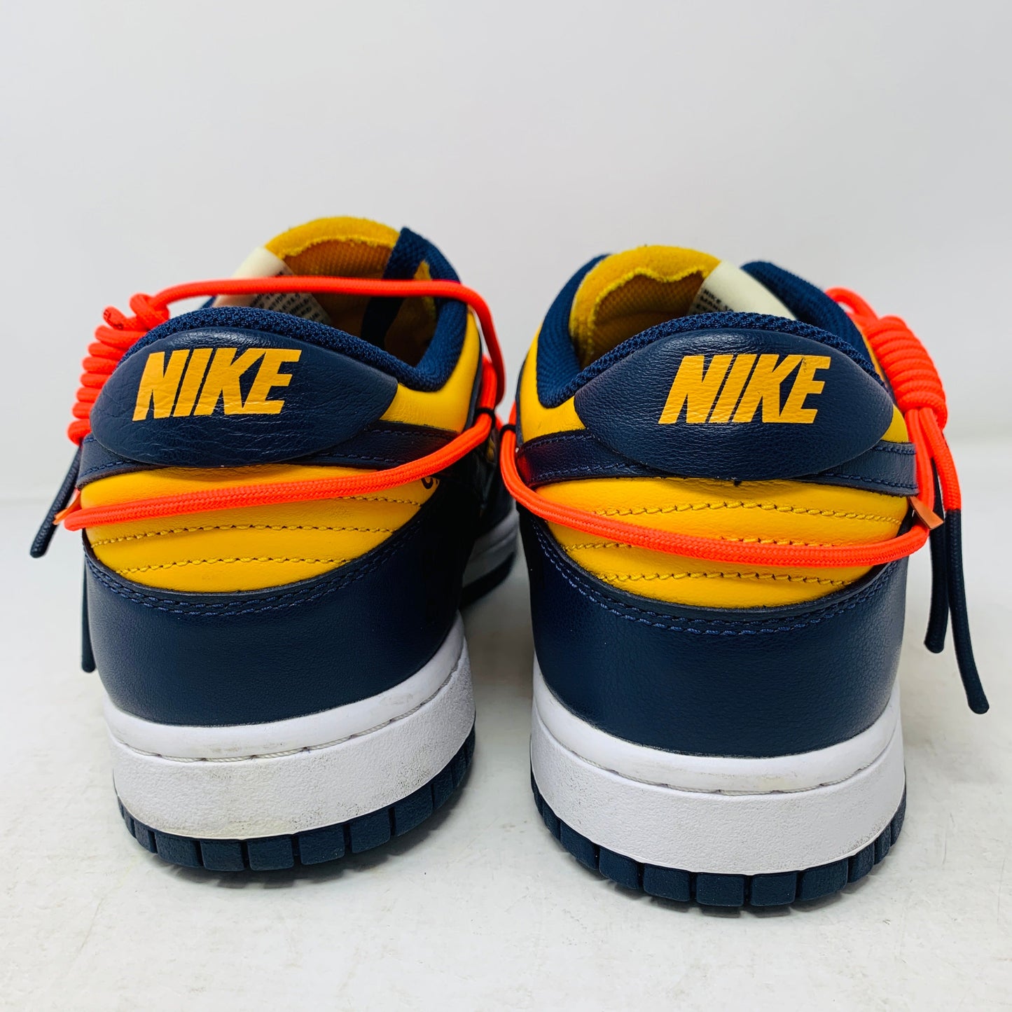 Nike Dunk Low Off-White University Gold sneakers, rear view.