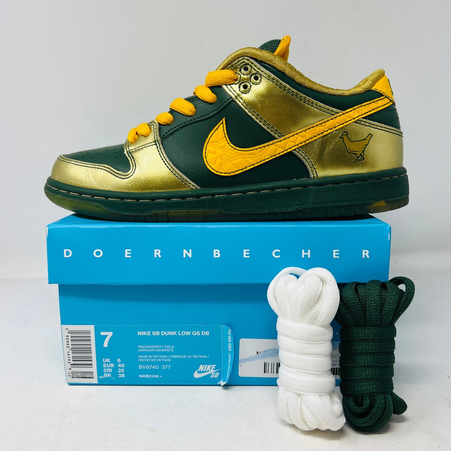 Nike SB Dunk Low Doernbecher 2018 sneakers with gold and green accents, extra laces, on original box.