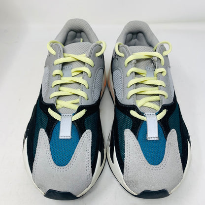 The adidas Yeezy Boost 700 Wave Runner sneakers from Yeezy feature a modern athletic design with a chunky sole, combining gray, black, white, teal colors with light yellow laces against a plain white background.