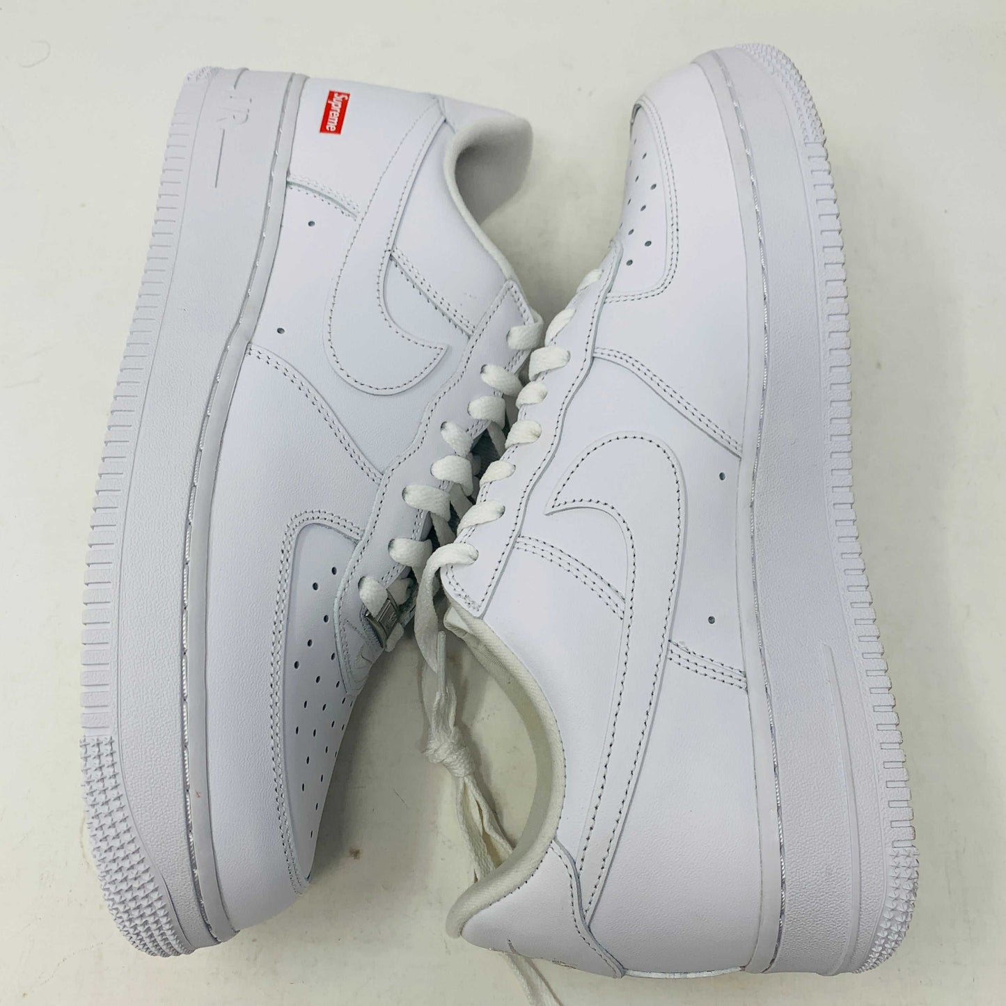 Supreme Air Force 1 White sneakers with classic design and Supreme branding.