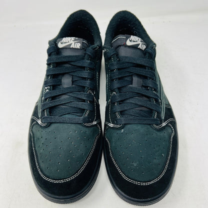 The Jordan 1 Retro Low OG SP Travis Scott Black Phantom sneakers feature a reversed swoosh logo and come in black and green, displayed on a box. They include two extra lace sets: red and black-and-white, ideal for maintaining the UPPERS CLEAN while ensuring an OG ALL style without heel drag.