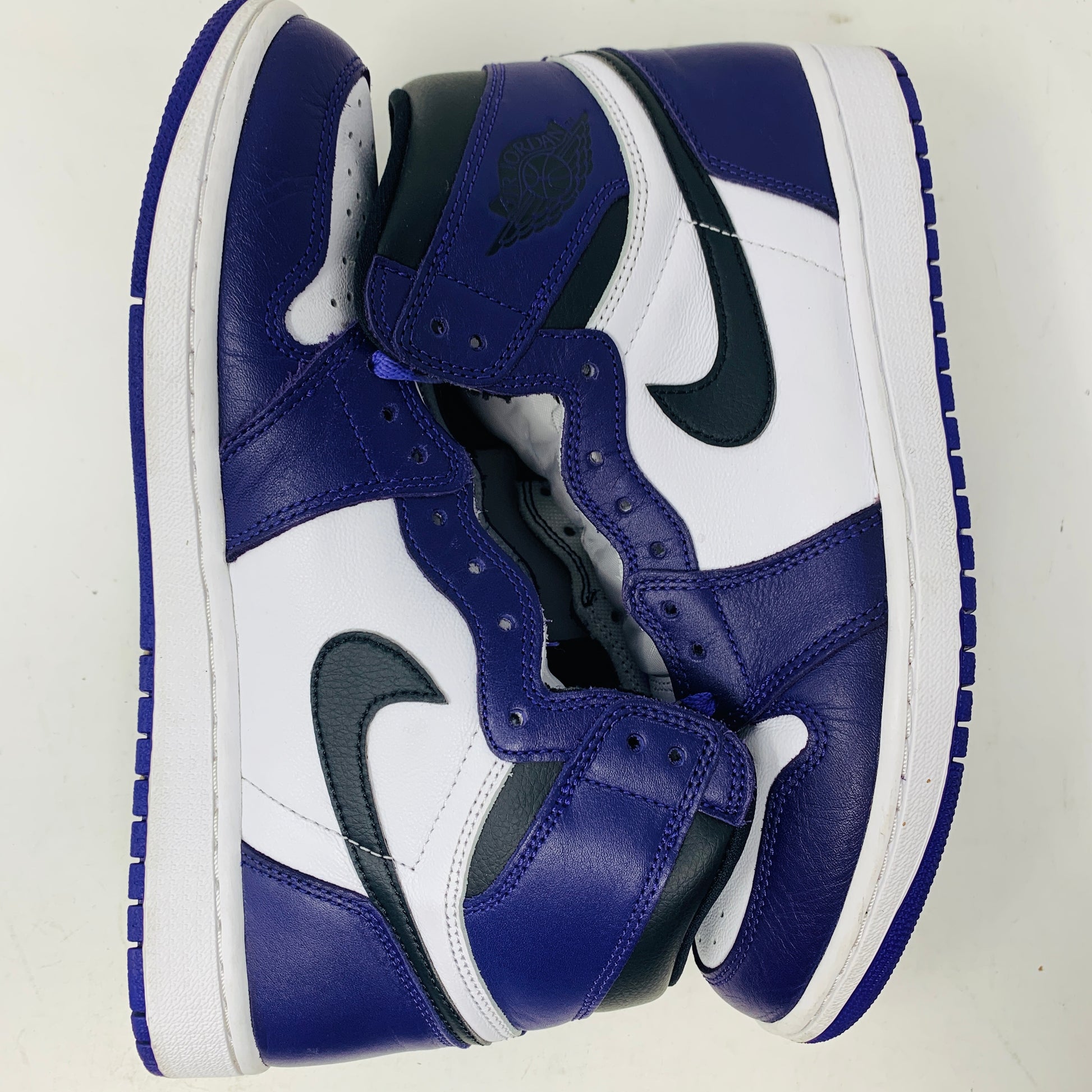 Jordan 1 Retro High Court Purple White sneakers size 9.5 on Nike box, purple and white uppers, black Swoosh, 2020 edition.