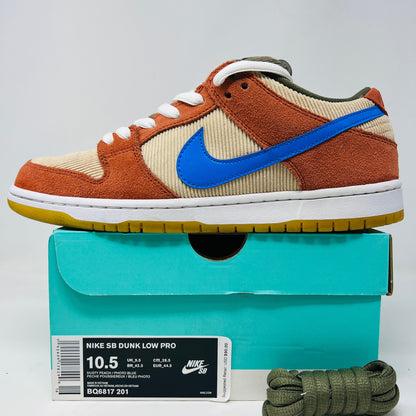 Nike SB Dunk Low Corduroy Dusty Peach sneakers with olive laces and blue swoosh displayed on box.