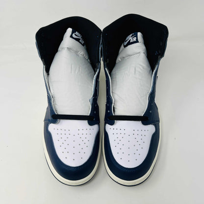 A brand new Jordan 1 Retro High OG Midnight Navy high-top sneaker, featuring navy blue, white, and black colors with the iconic swoosh and Air Jordan logo, displayed on a matching shoe box.