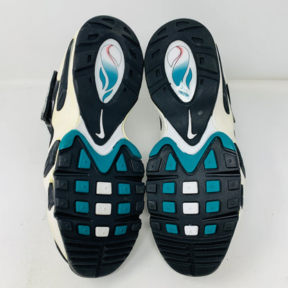 The image displays the soles of genuine Nike Air Griffey Max 1 White Freshwater (2016) athletic shoes with a black, white, and teal design. The sole features a unique pattern with teal blocks, a white Nike logo, and stylized graphics of a pin and baseball in pristine 9M condition.