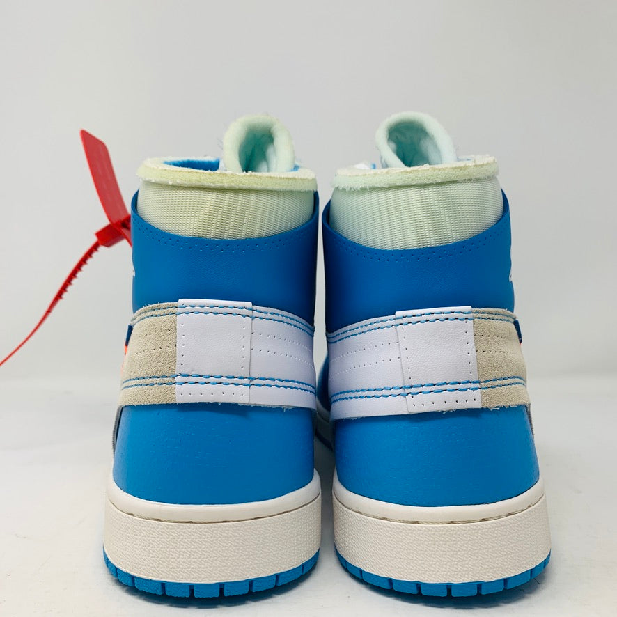 The Jordan 1 Retro High Off-White University Blue by Jordan, featuring a red tag, white accents, and light green inner lining, is viewed from the back on a plain white surface.