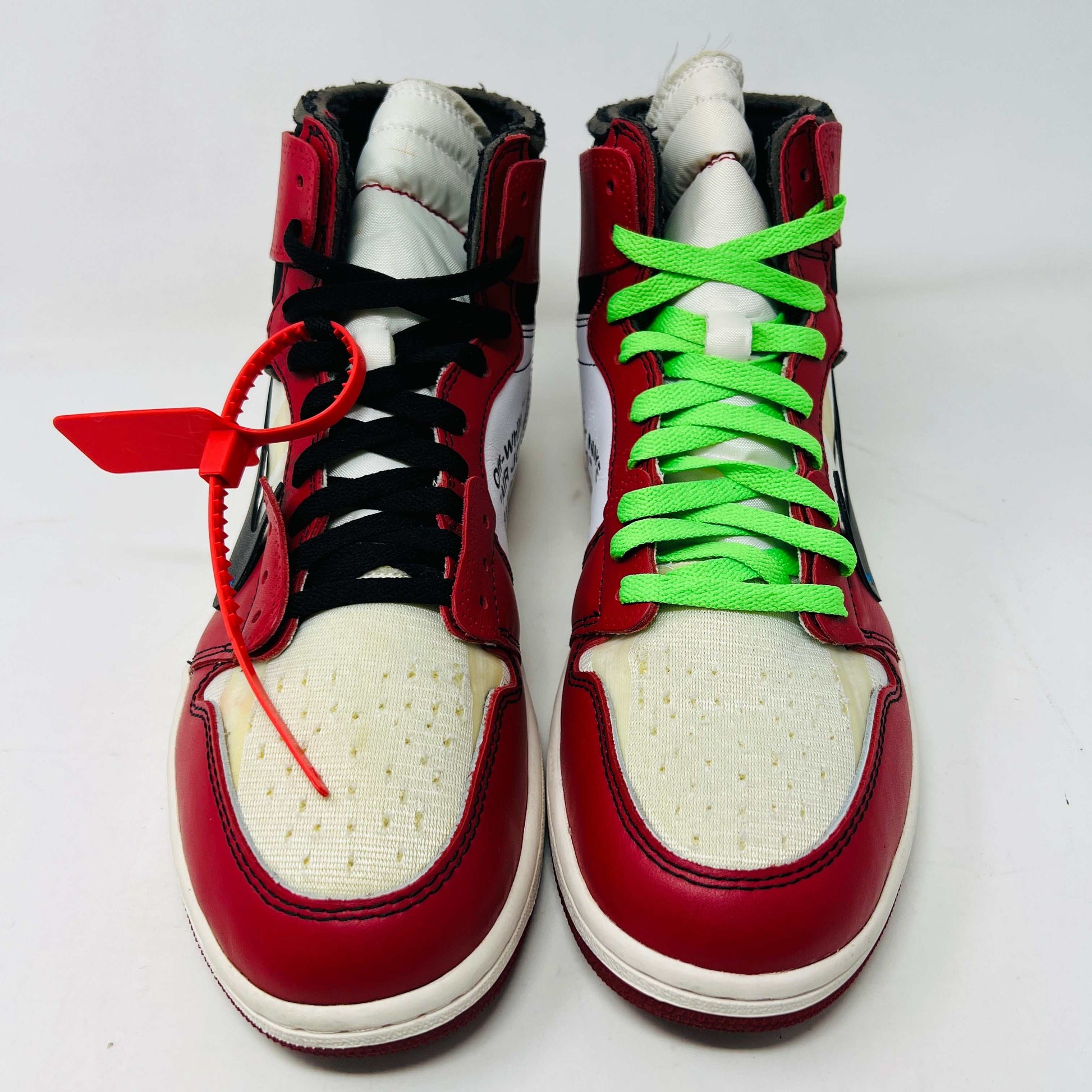 Jordan 1 Retro High Off-White Chicago sneakers in red and white with unique lacing.