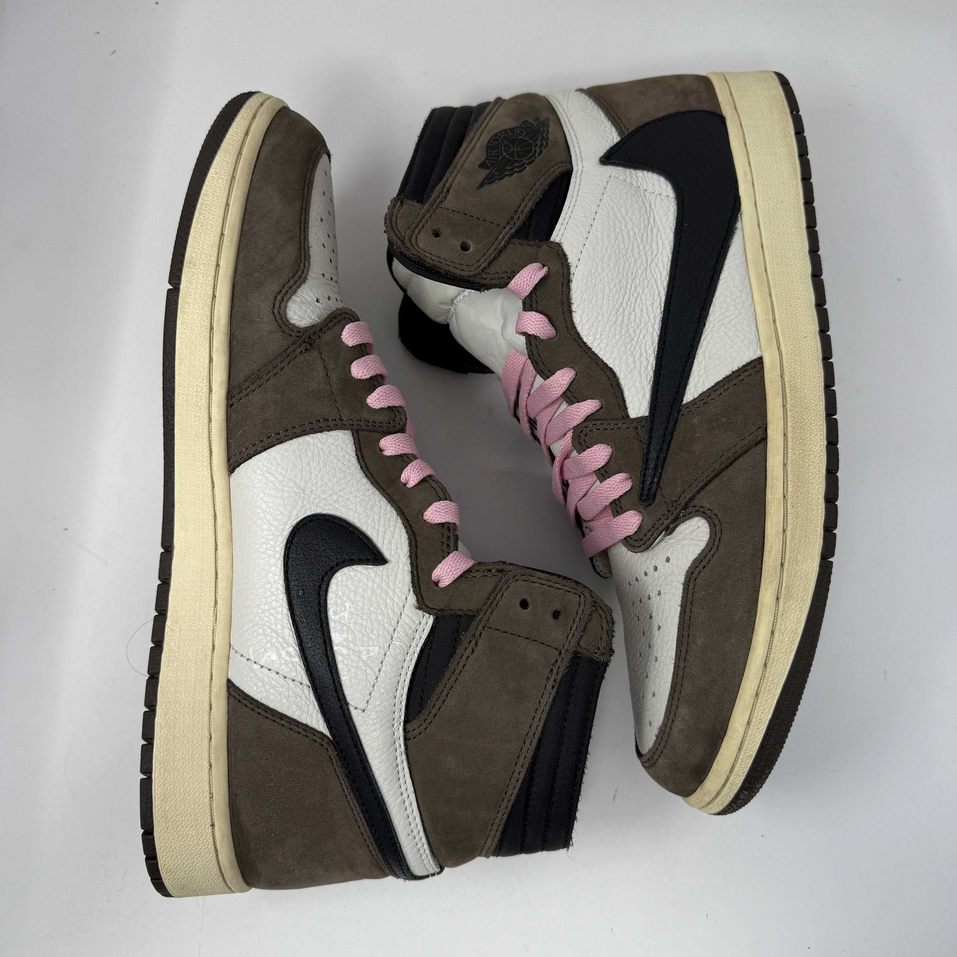 Jordan 1 Retro High OG SP Travis Scott Mocha sneakers in mocha brown and black with pink laces.