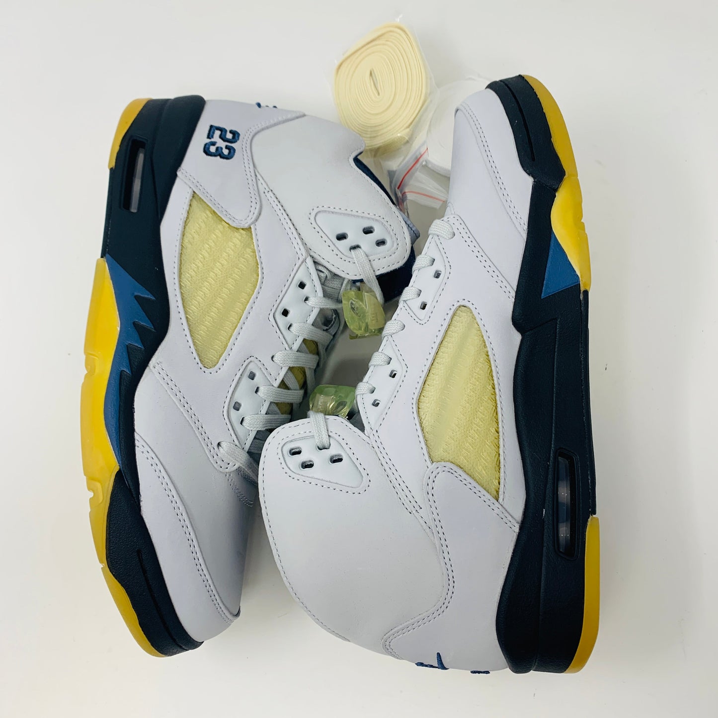 Jordan 5 Retro A Ma Maniére Dawn Women's sneakers in white, black, and gold with Jordan logo.