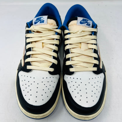 The Jordan 1 Retro Low OG SP Fragment x Travis Scott features a cream and black upper, blue heel and collar, and a cream sole with a signature swoosh design. Displayed against a plain backdrop without a box, it includes extra laces for versatility.