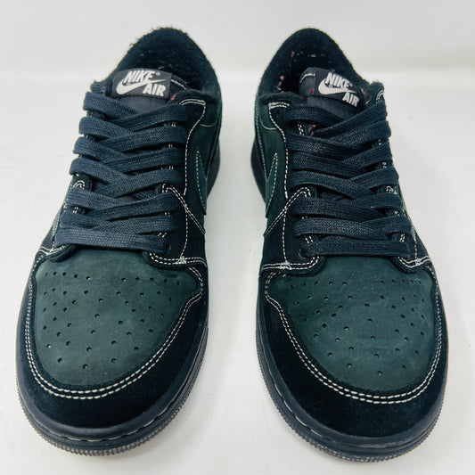 The Jordan 1 Retro Low OG SP Travis Scott Black Phantom is a stylish sneaker featuring a dark green suede upper with black leather accents, packed in a black shoebox. It comes with red and black-and-white patterned spare laces, showcasing its original swoosh design.