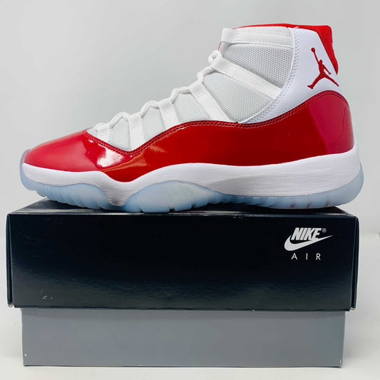 Jordan 11 Retro Cherry 2022 sneaker in white and red with patent leather details on a Nike box.