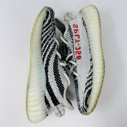 adidas Yeezy Boost 350 V2 Zebra sneakers with black and white pattern.