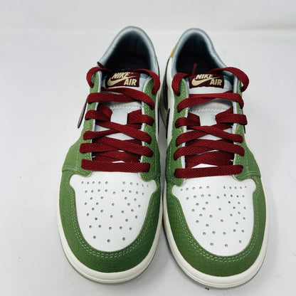 A pair of Jordan 1 Retro Low OG Year of the Dragon sneakers in green, white, and red. They feature red laces, a perforated white toe cap, and the Nike Air logo on the tongue against a plain white background.