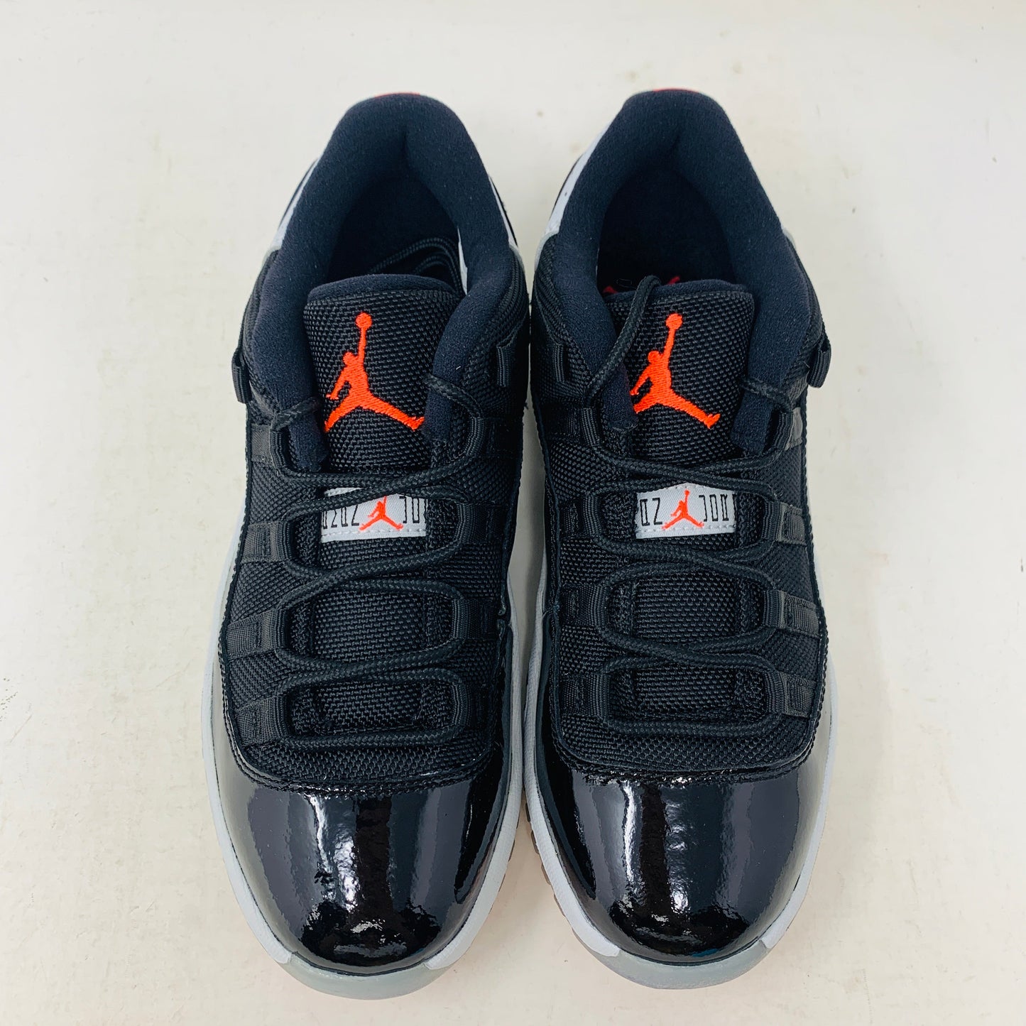 Jordan 11 Retro Low Infrared PS sneakers in black and infrared, featuring Jumpman logo.