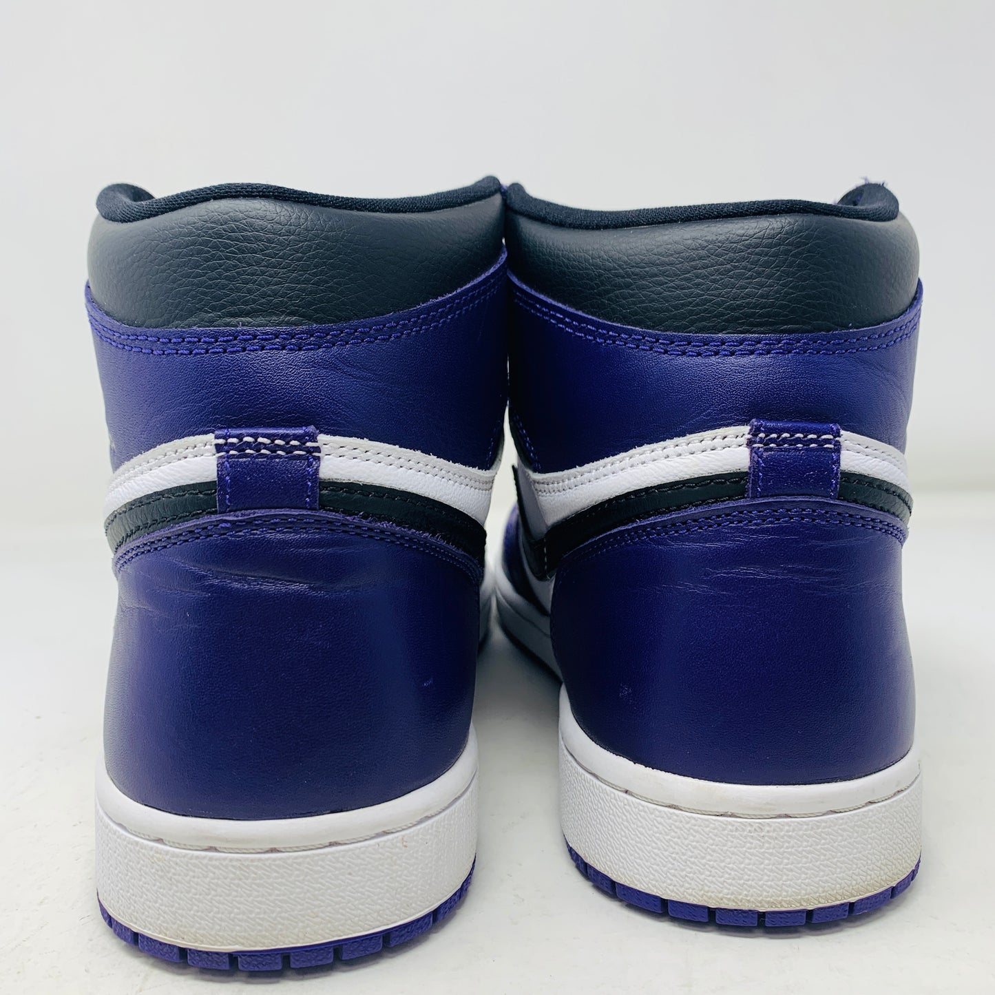 Jordan 1 Retro High Court Purple White sneakers size 9.5 on Nike box, purple and white uppers, black Swoosh, 2020 edition.