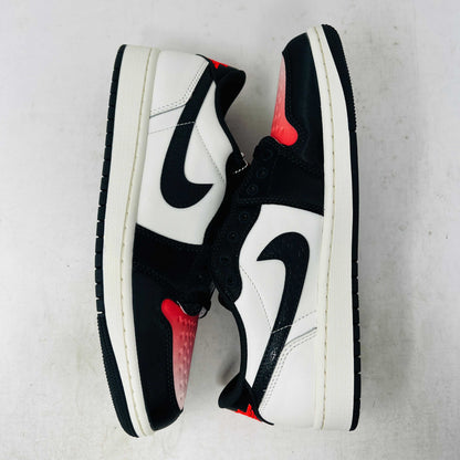 Authentic, brand new Jordan 1 Retro Low OG PSG Paris Saint-Germain sneakers by Jordan are displayed on a matching shoebox. The shoes feature a textured black swoosh and striking red toebox against a plain white background.