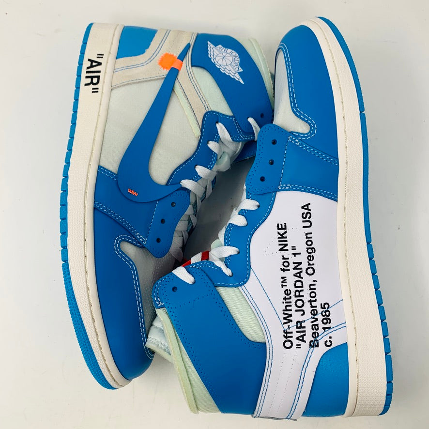 The Jordan 1 Retro High Off-White University Blue sneakers, a collaboration with Nike, feature AIR on the sole and side text with Beaverton, Oregon USA and year c. 1985.