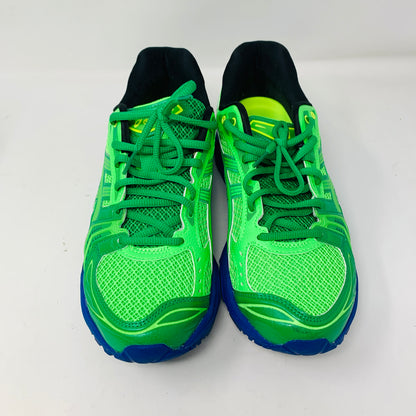 The ASICS Gel-Kayano 14 Field Trip Recordings Fern Green shoes feature vibrant green with dark blue soles and black interiors against a white backdrop. They combine mesh and synthetic materials with lace-up closures.