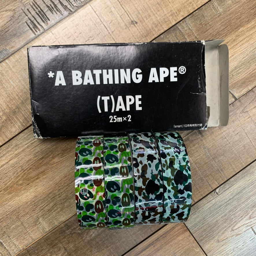 Bape Tape 4 Pack in camouflage design on wooden floor background.