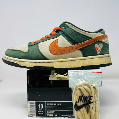 The Nike SB Dunk Low Eire by Holy Ground features a green and beige colorway with an orange swoosh and logo detail on the heel. It comes with a black box, extra Nike laces, ensuring authenticity and versatility.