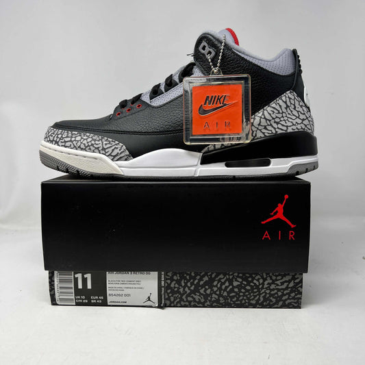 Jordan 3 Retro Black Cement 2018 sneaker with black leather, cement grey details, and red accents on box.