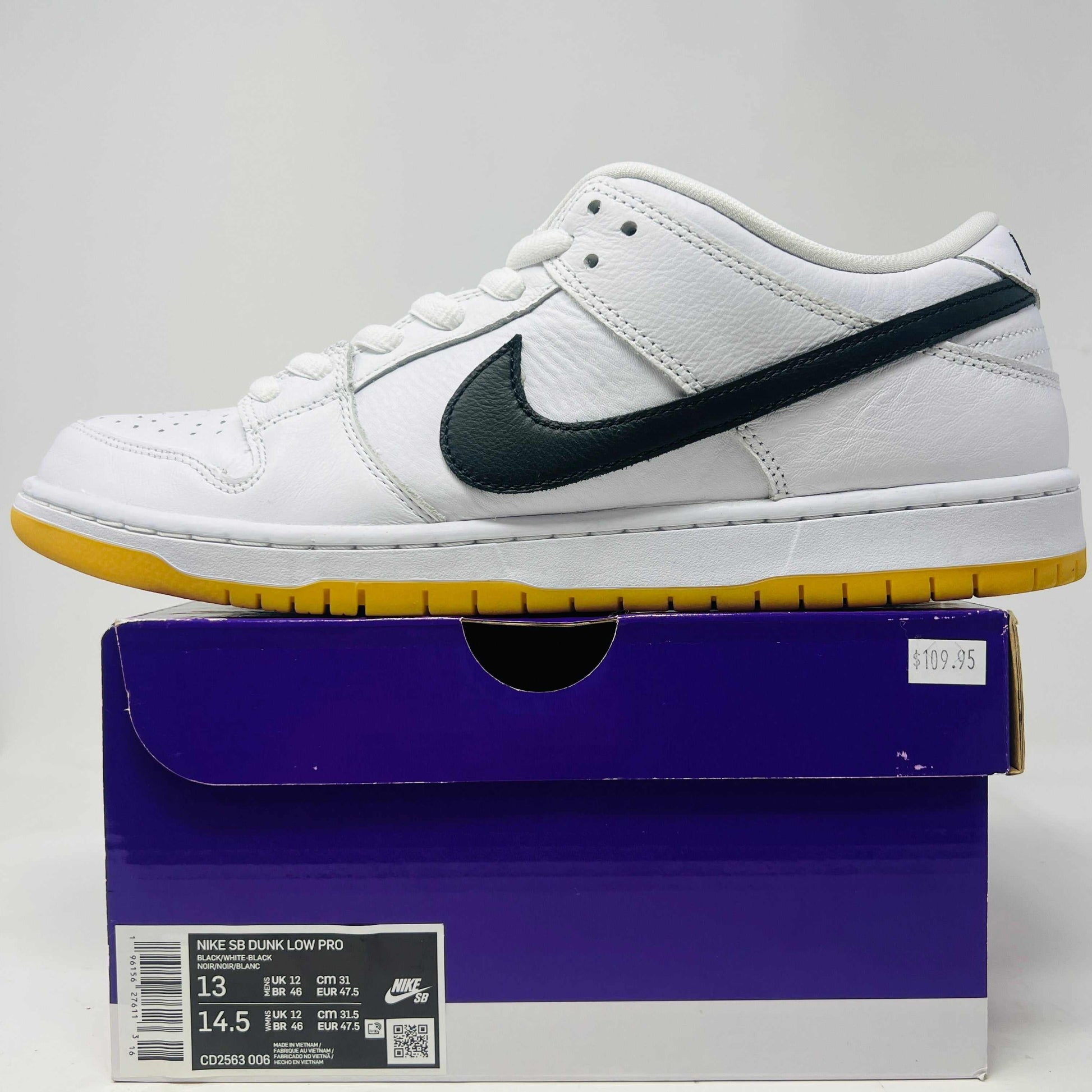 Nike SB Dunk Low Pro White Gum sneakers, size 13, displayed on box, slight wear.