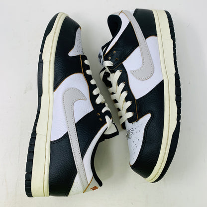 The Nike SB Dunk Low HUF San Francisco sneakers, updated for 2022, feature a prominent gray swoosh design on the side with black and white colors, white laces, black soles, and a textured finish.