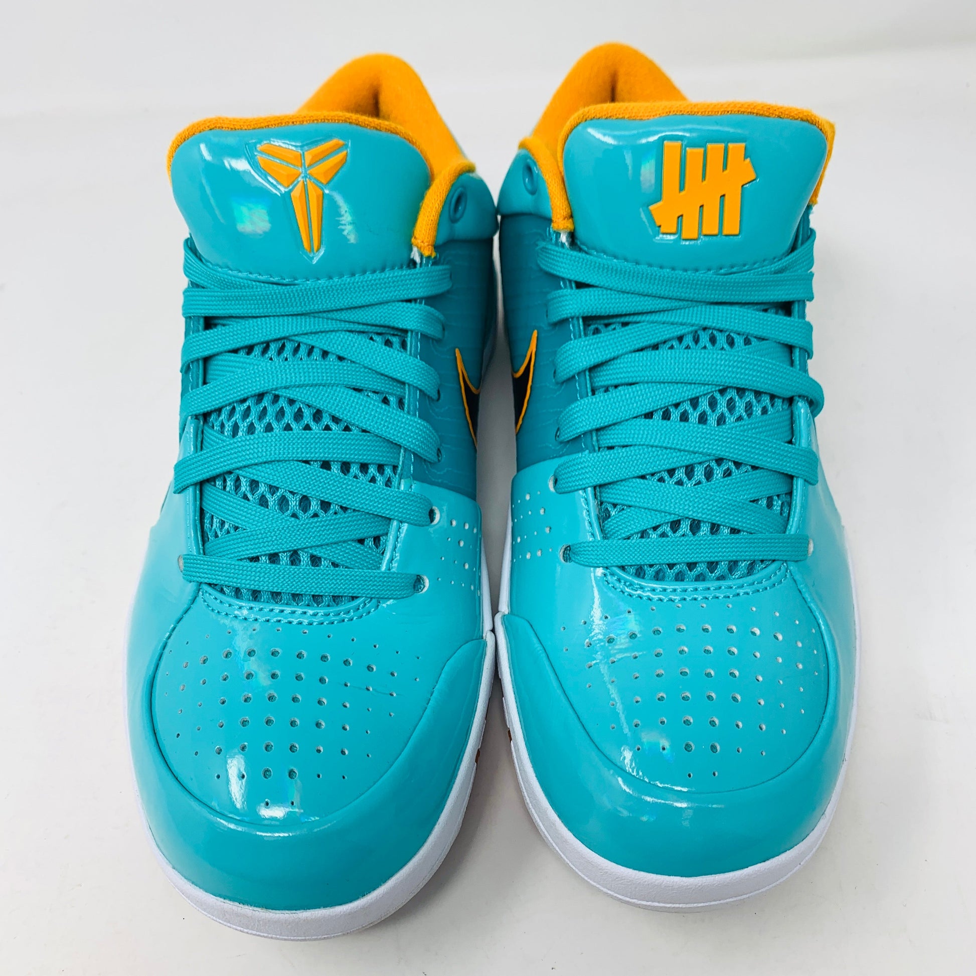 Nike Kobe 4 Protro Undefeated San Antonio Spurs sneakers, teal with orange accents, slight toe and midsole creasing, includes orange laces, 2019 release.