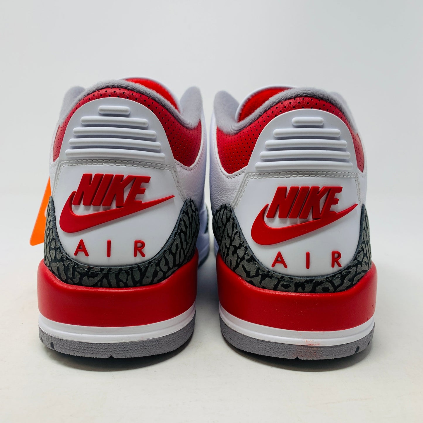 Jordan 3 Fire Red 2022 sneakers with white leather, red accents, and elephant print detailing.