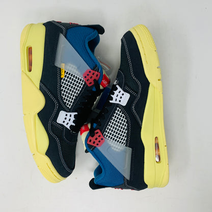 The Jordan 4 Union Noir sneaker in black, yellow, blue, and red is 100% authentic and brand new. It features a visible air unit in the heel, a translucent tab with the Jumpman logo, a matching shoebox, and extra laces for versatility.