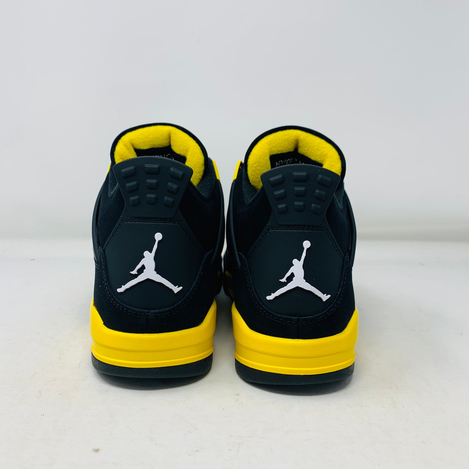 Jordan 4 Thunder 2023 brand new sneakers with black and yellow design.