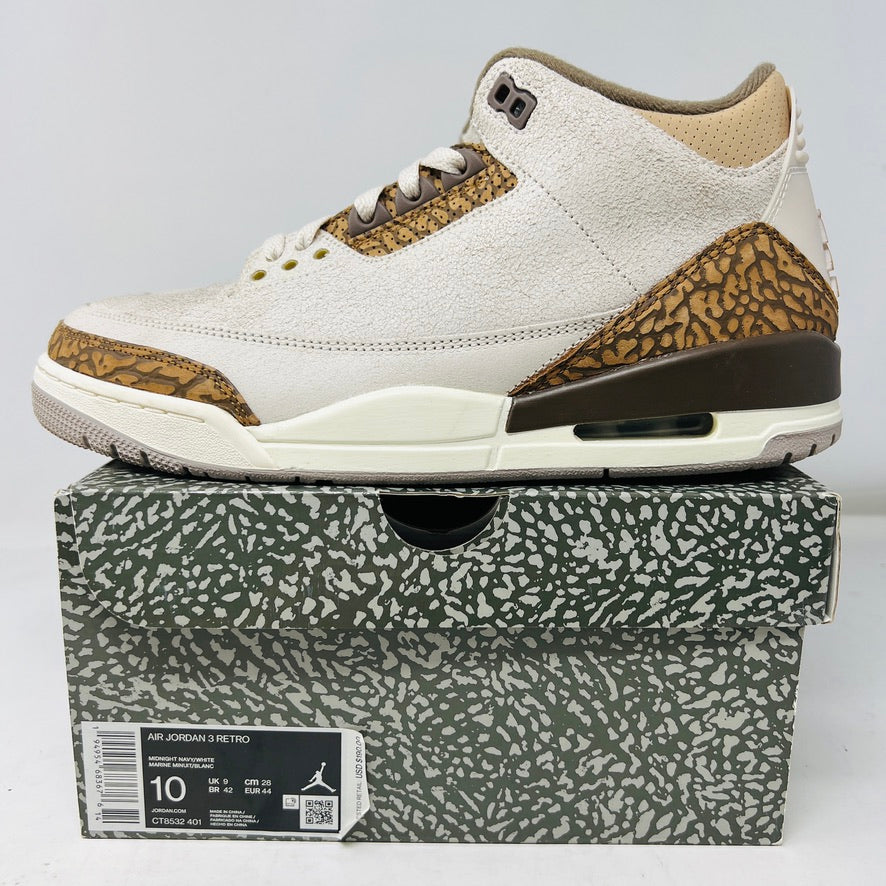 The Jordan 3 Retro Palomino, from the 2023 collection, features clean beige and brown uppers, textured brown accents, white laces, and a white midsole with a visible air unit. Its paired with a unique green and gray patterned replacement box.