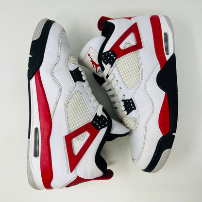 The Jordan 4 Retro Red Cement sneakers, by Jordan, are showcased on their box. They feature authentic white leather, clean uppers with red accents, black netting, and visible air cushioning. The textured box includes a size label.