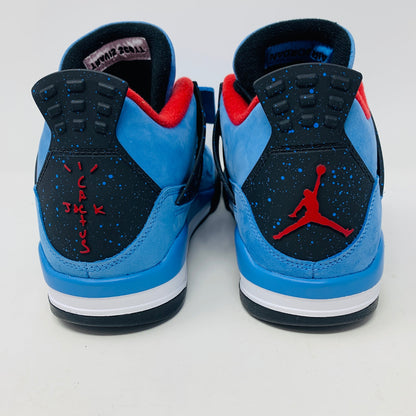 The Jordan 4 Retro Travis Scott Cactus Jack sneaker in blue, accented with black and red, features a visible air unit in the heel and a Jumpman logo hang tag, packaged in a black speckled box with an orange Jumpman logo and AIR.