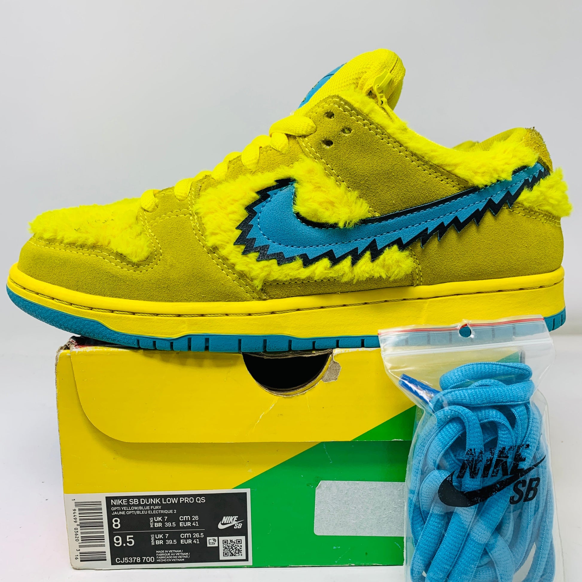 Nike SB Dunk Low Grateful Dead Bears Opti Yellow sneakers with extra blue laces.