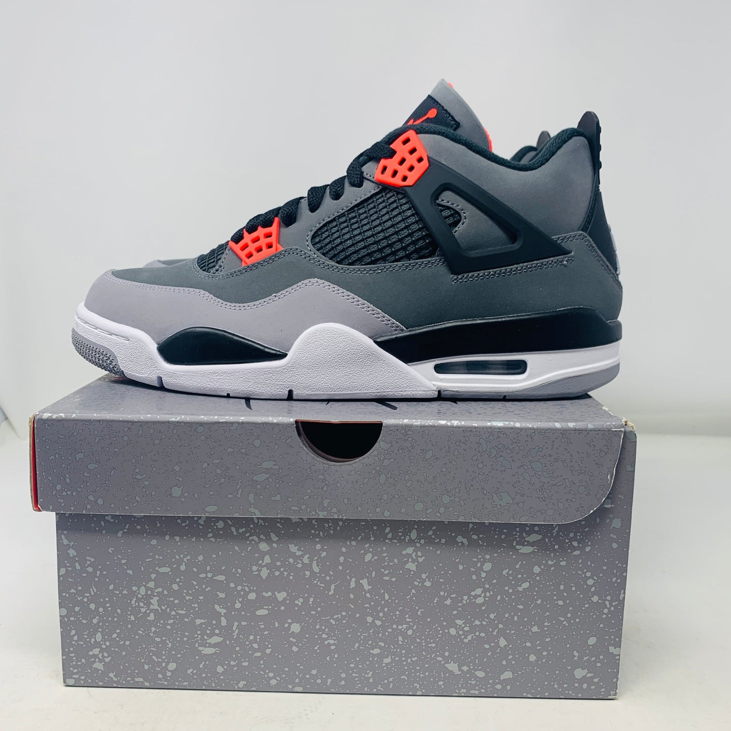 Jordan 4 Infrared sneakers in brand new condition on top of original box.