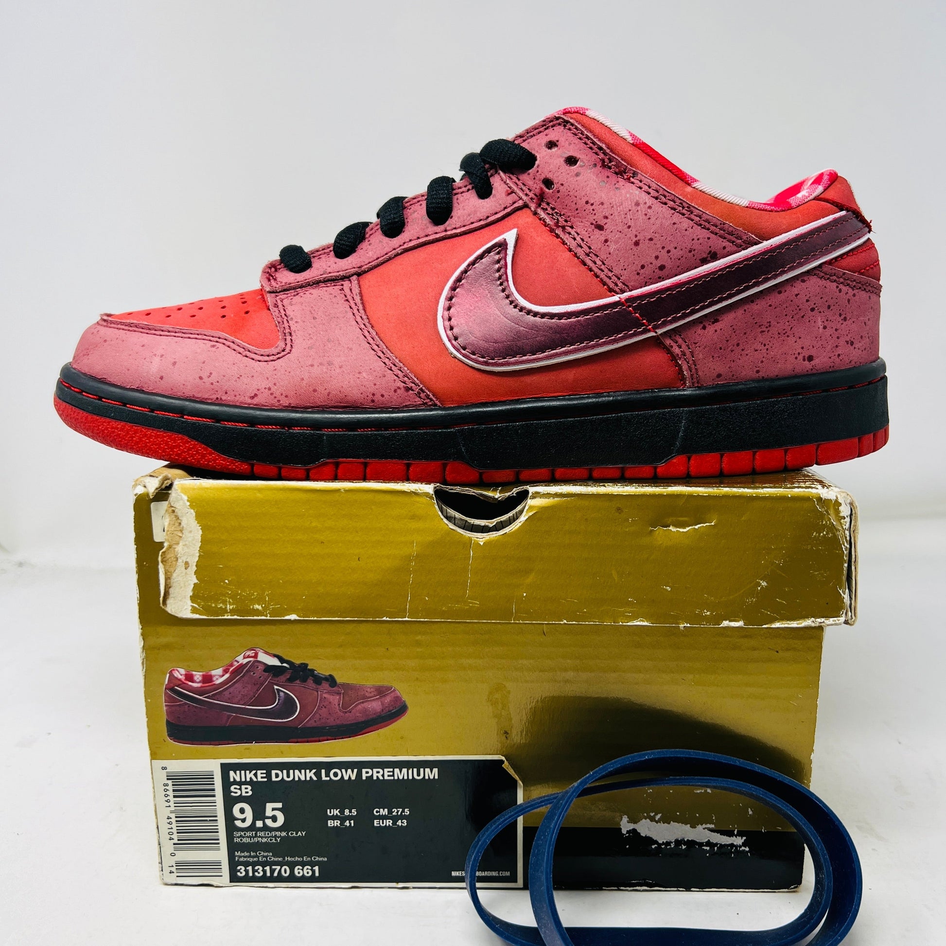 Nike SB Dunk Low Concepts Red Lobster sneakers with discolored toe box, on a damaged box, includes bands, 2008 edition.