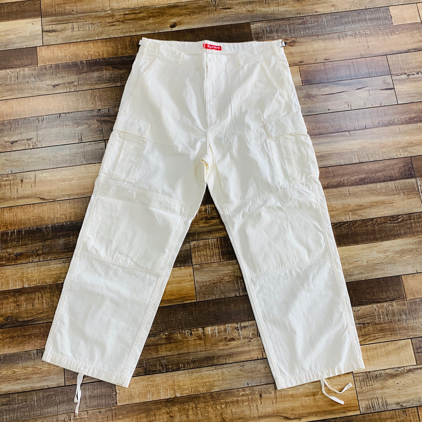 Supreme Cargo Pant SS24 Stone brand new on wooden floor.