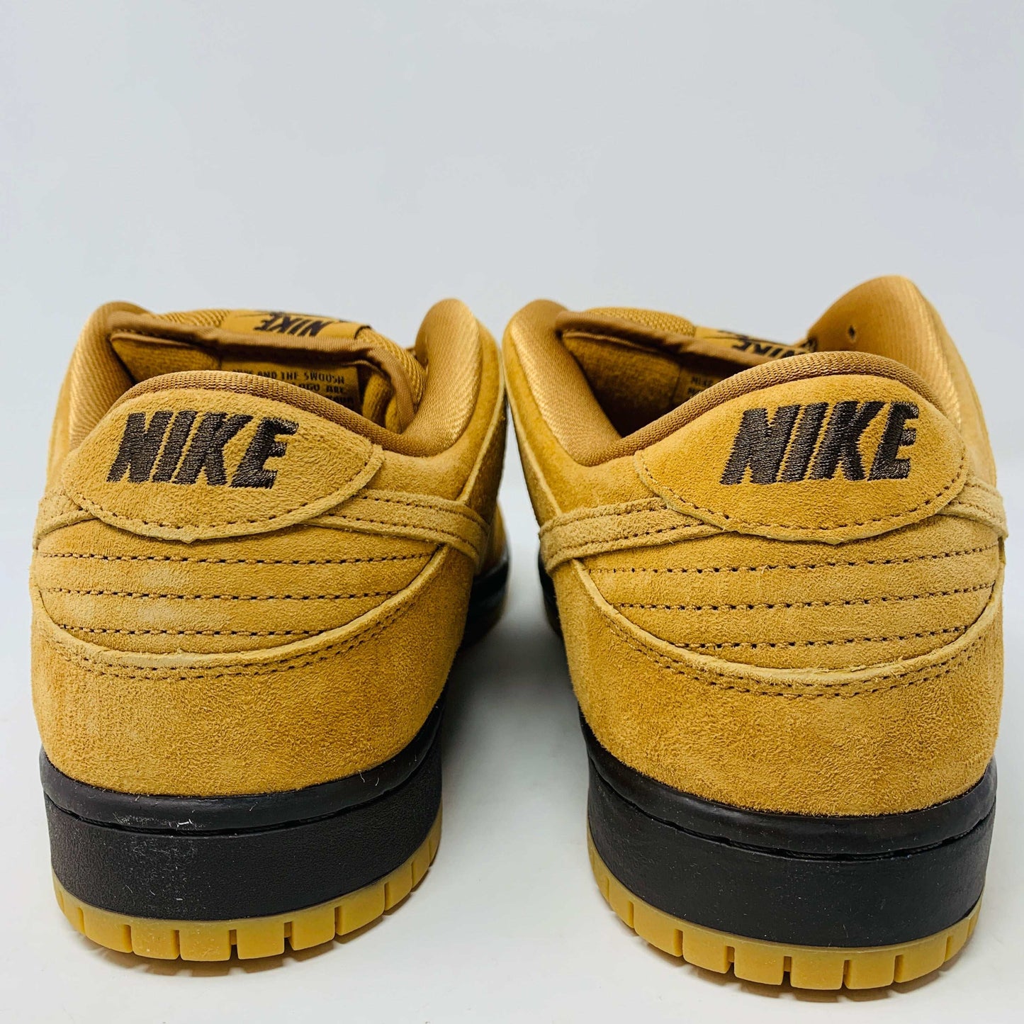 Nike SB Dunk Low Wheat sneakers 2021/2023 with wheat-colored suede, low-top design, white midsole, and iconic swoosh.