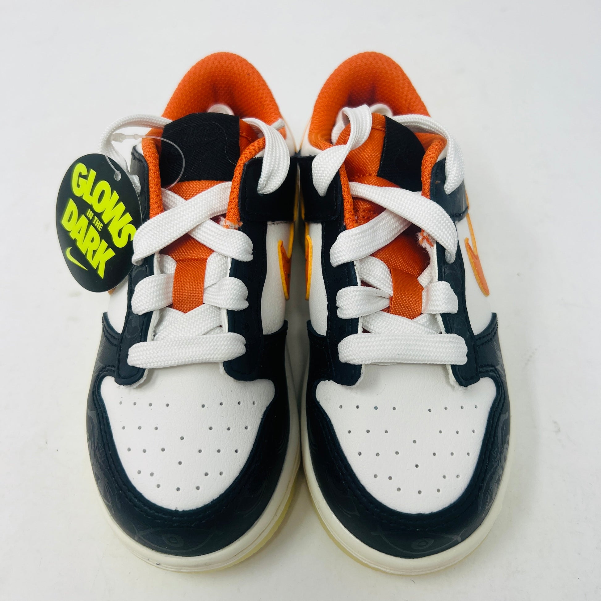 Nike Dunk Low PRM Halloween 2021 toddler shoes with black, white, and orange glow-in-the-dark design.