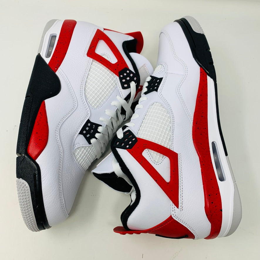 The exclusive Jordan 4 Retro Red Cement sneakers, featuring a distinctive design with white mesh panels and red and black accents, are showcased facing each other on a white background.