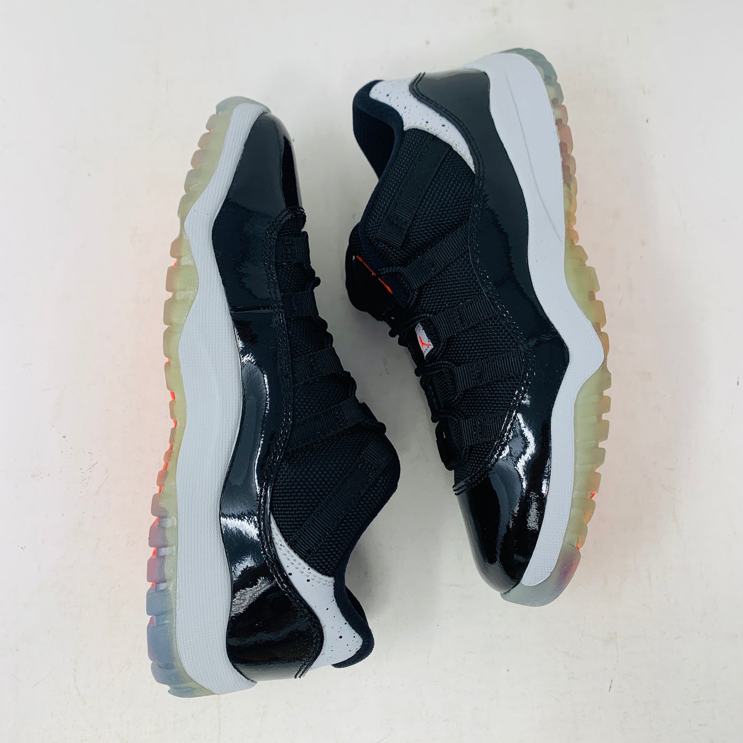 Jordan 11 Retro Low Infrared PS black and infrared sneakers with premium leather and mesh design.